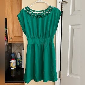 Green dress with neckline cutouts and cinched waist